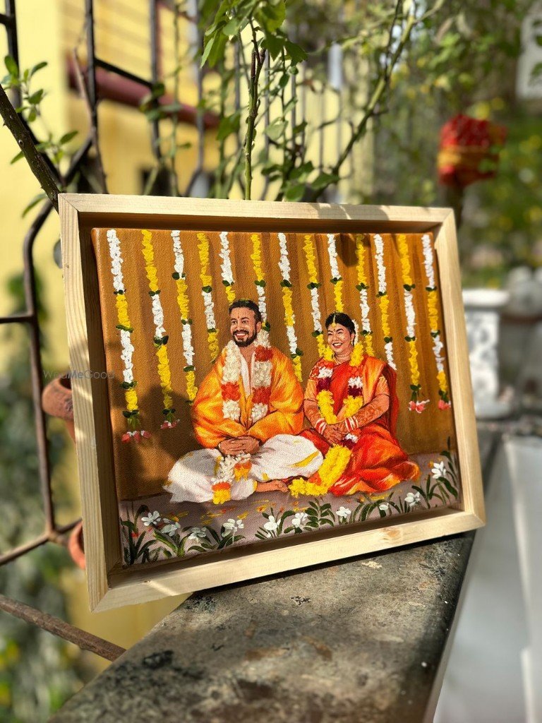Framed live wedding painting — couple in traditional Indian wedding attire and floral garlands, hand-painted on canvas